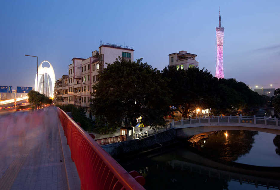 Guangzhou TV tower and Bridge seen over a small water village in Tianhe district