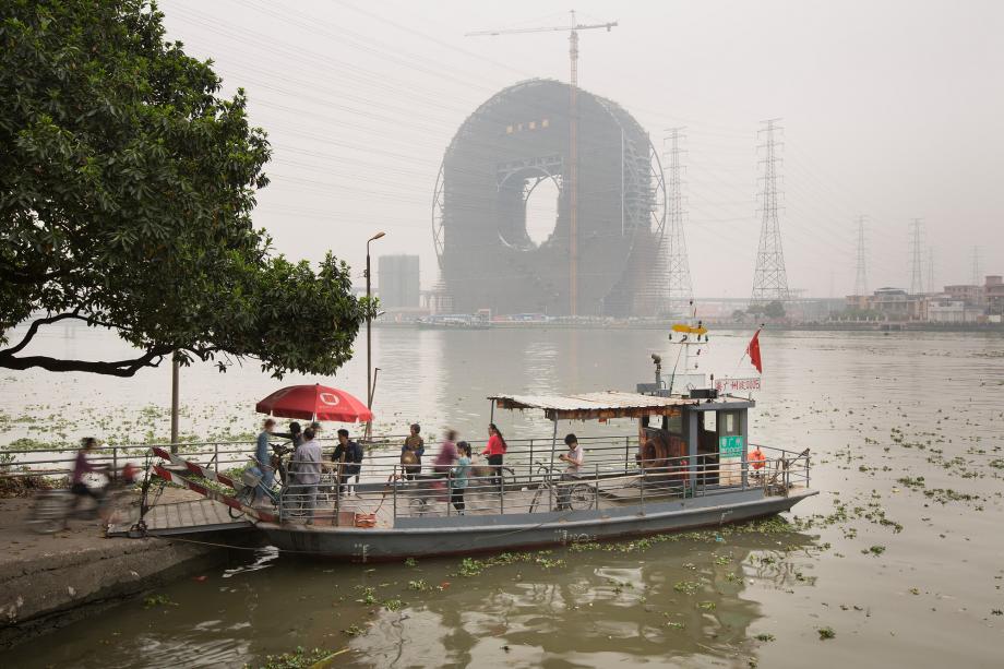 People board a ferry on the Pearl River in Panyu, Guangzhou