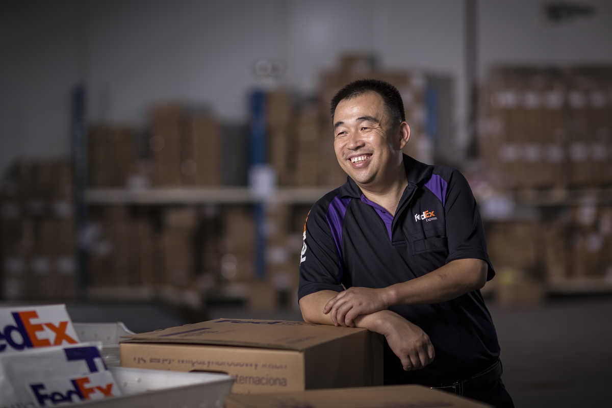 Industrial photograph of Qing Hua, a FedEX worker in Shenzhen.