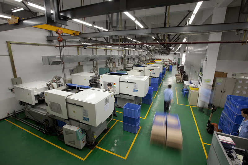 A worker moves a pallet at the ICCNexergy factory in Dongguan.