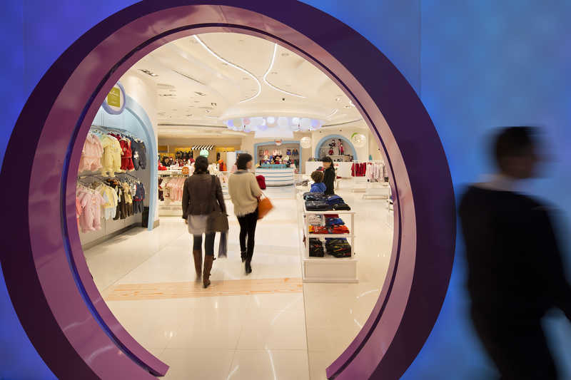 People walk through the Kid's Cavern department store inside the Sands Cotai Central resort shopping mall