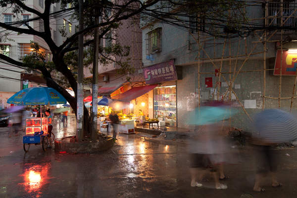 People walk along narrow streets in Cencun village in Tianhe District