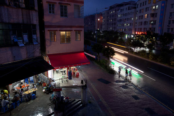 People wait to cross a slick street in Cencun