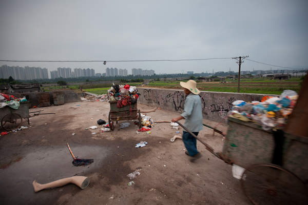 A man carts garbage in Cencun village