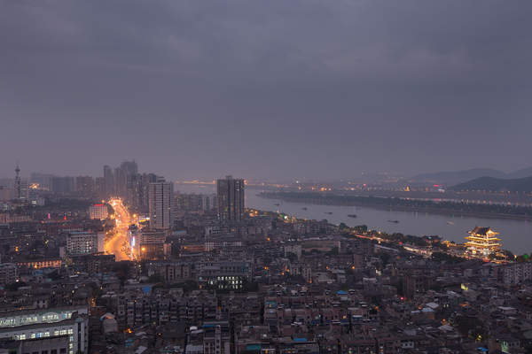 Changsha is illuminated at dusk along the banks of the Xiangjiang river