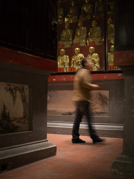 A man walks through a building at the Kaifu Temple