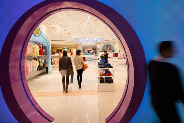 People walk thorugh the Kid's Cavern department store in Macau, China