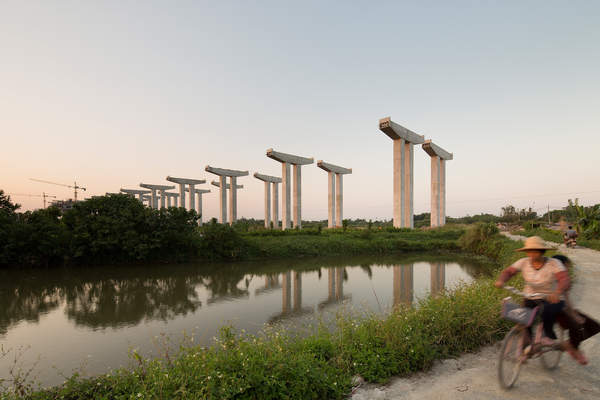 People ride a bicycle near Xiyong in Panyu