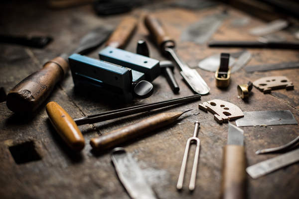 A violin bridge and violin making tools are arranged at Slavko Domitrovic's workshop