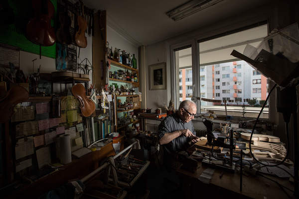 Violin maker Jan Majersky poses at his workshop