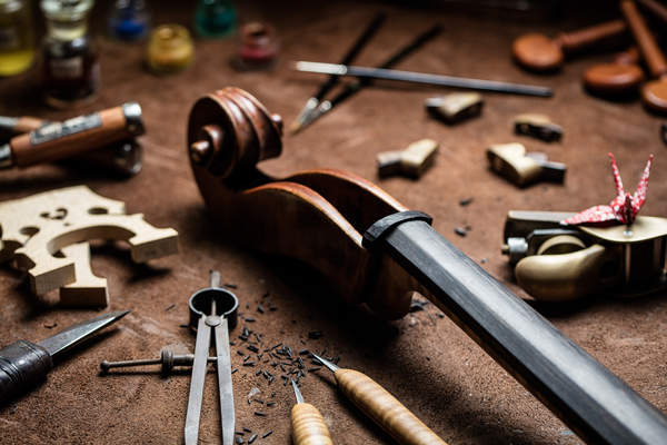 A cello and violin restoration tools are displayed at Céline Garnier's workshop