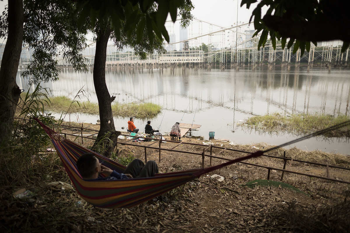 People fish at the Honey Lake theme park in Futian, Shenzhen.