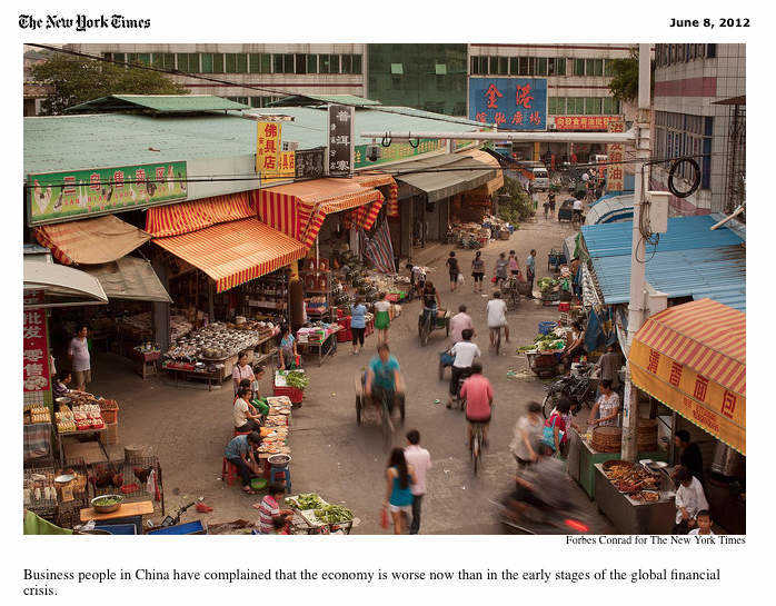 People walk through a market in Qingxi, Dongguan, Guangdong Province, China