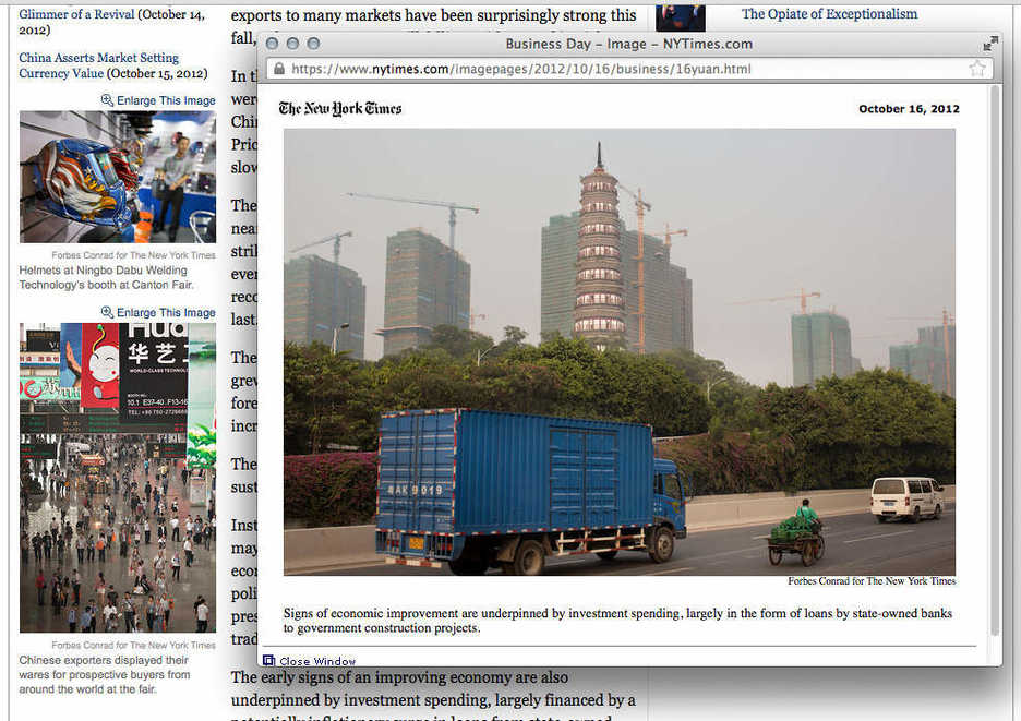 Vehicles pass by the Pazhou Tower and a new residential development in Guangzhou, China