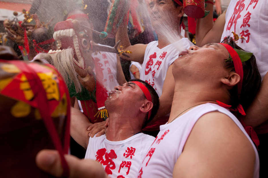 A group of Drunken Dragon dancers spit alcohol into the air
