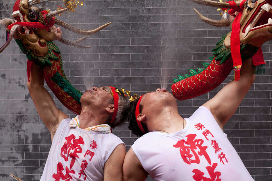 Two Drunken Dragon festival performers spew beer in the air