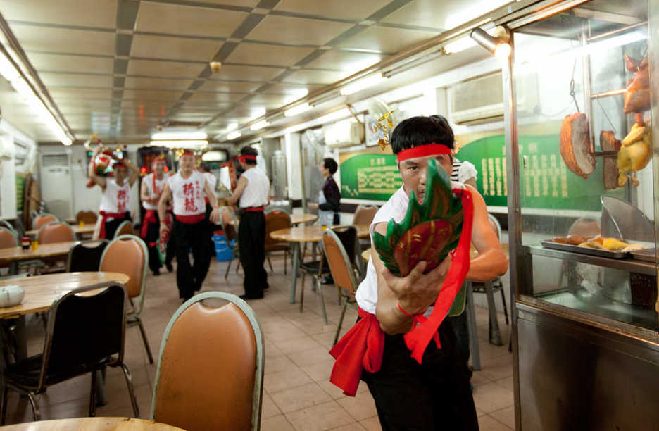 Drunken Dragon dancers make their way through a Macau restaurant