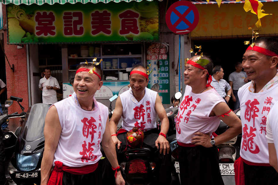 A group relaxes on parked motorcycles