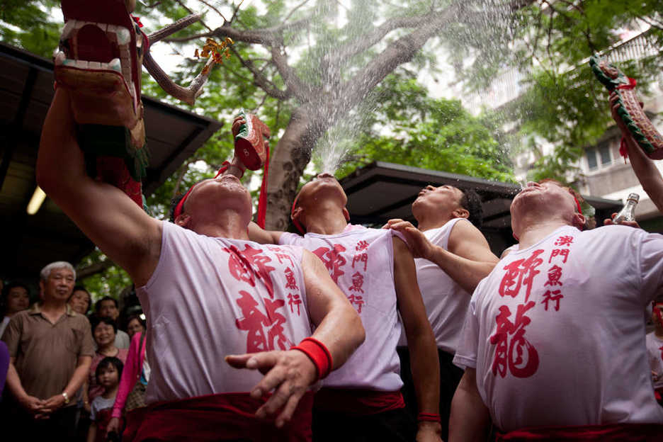 Revelers spew alcohol in front of a market in northern Macau.