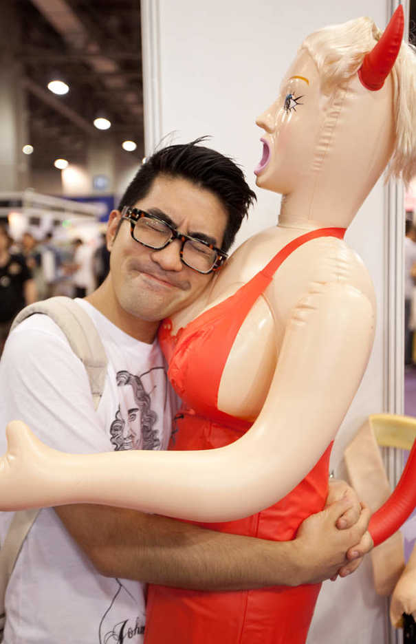 Asia Adult Expo guest embraces an inflatable sex doll
