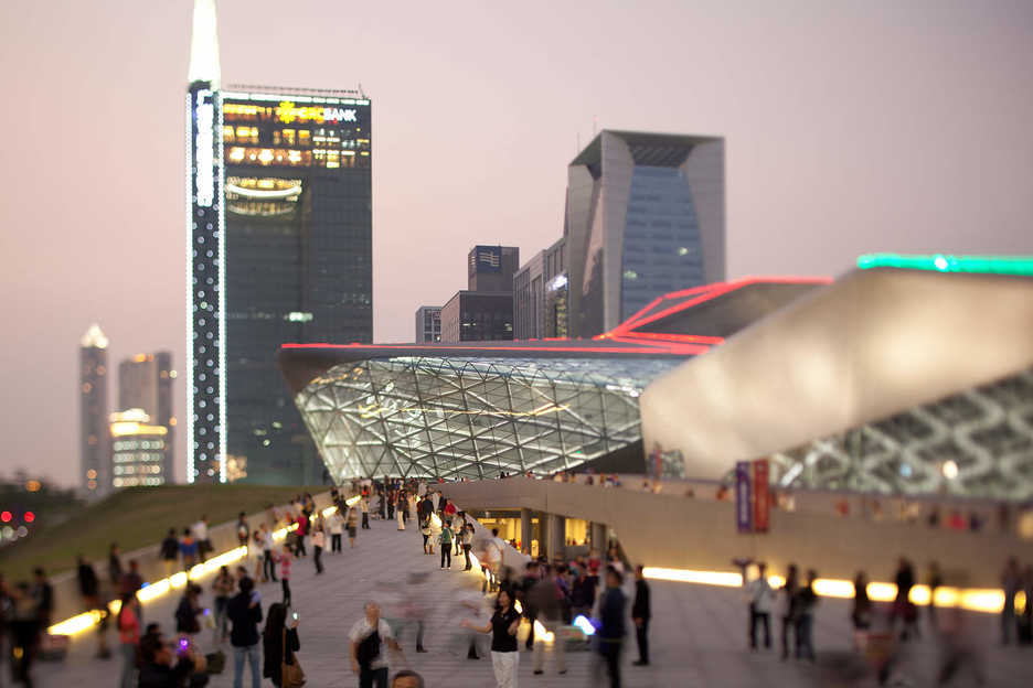 People surround the Guangzou Opera House in Guangzhou, China.