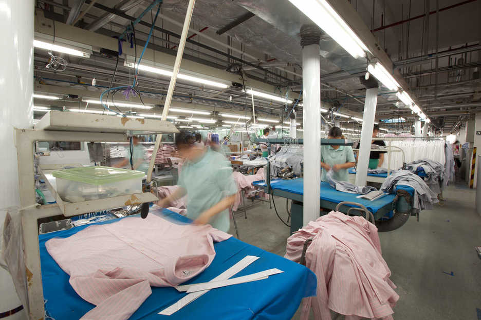 Workers press shirts at the Lever Style factory in Guan Lan, Shenzhen, China