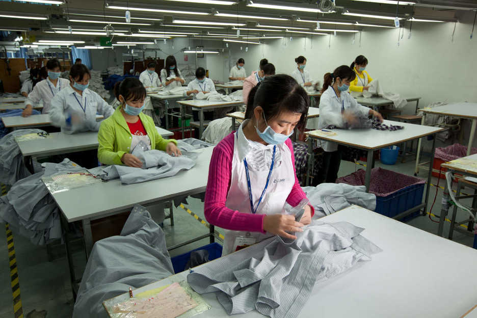 Workers inspect shirts at the Lever Style factory in Guan Lan, Shenzhen, China