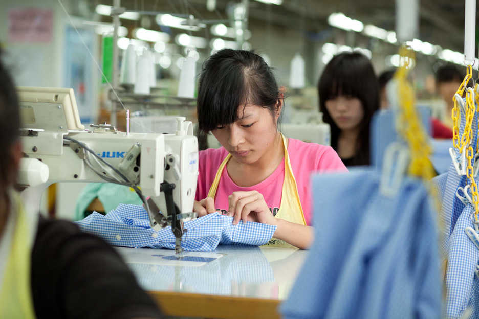 Workers sew shirts at the Lever Style factory in Guan Lan, Shenzhen, China
