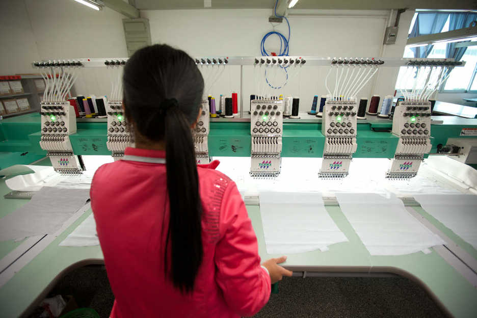 A worker uses a computerized sewing machine at the Lever Style factory Shenzhen