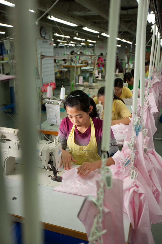 Workers sew shirts at the Lever Style factory in Guan Lan, Shenzhen, China