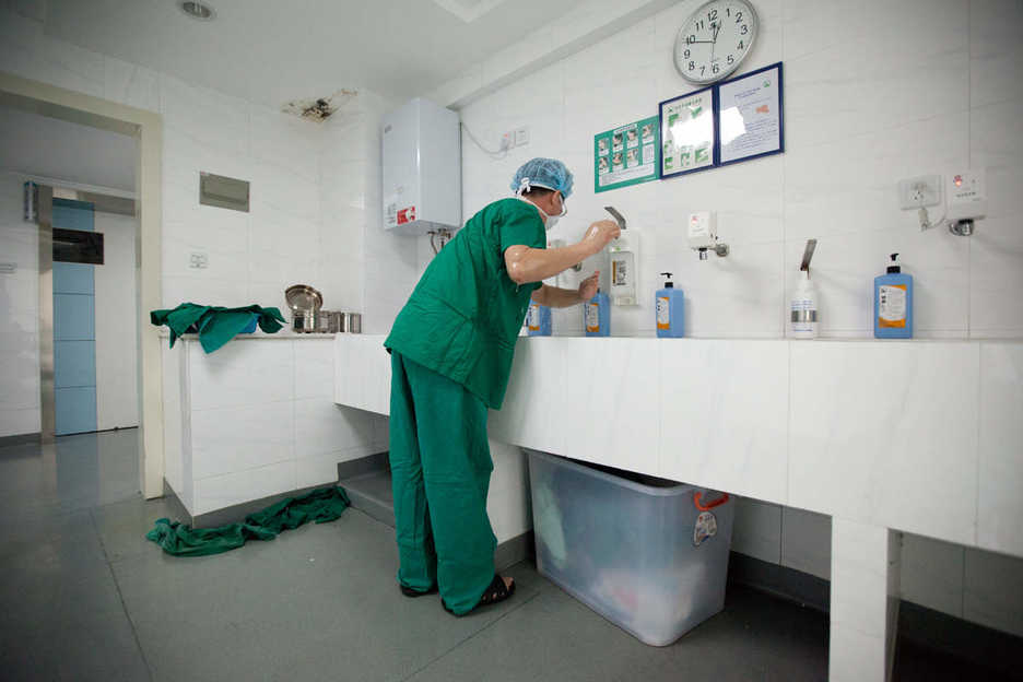 Shenzhen physician Li Yujie washes his hands after performing nose augmentation