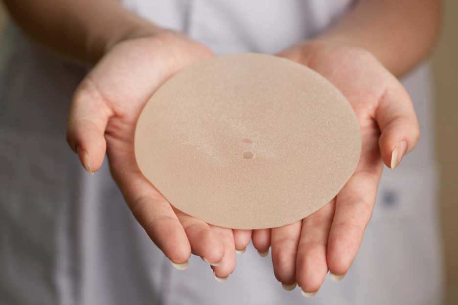 Medical staff member holds silicon breast implant at Shenzhen Humanity Hospital
