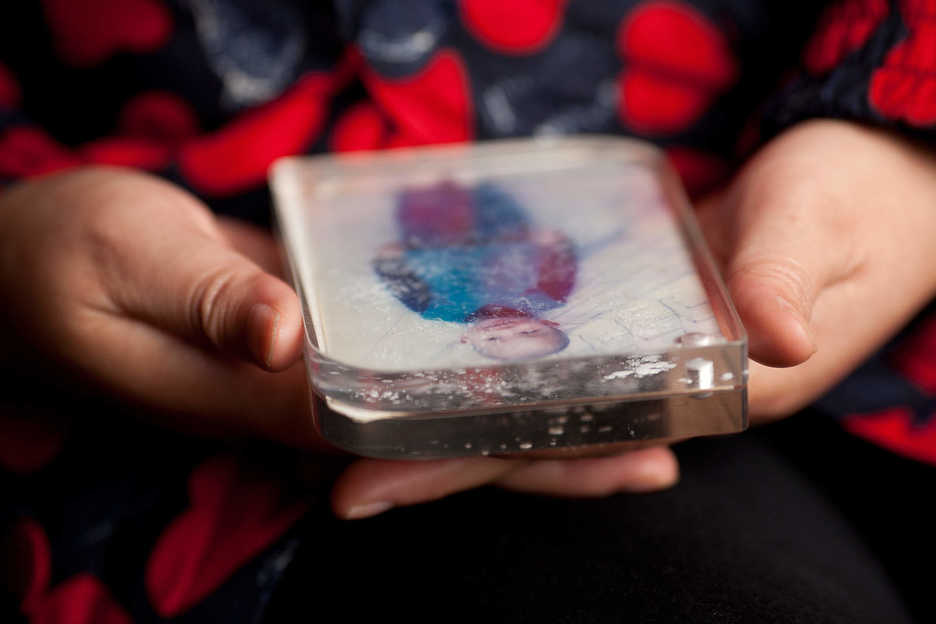 Peng Haiying holds a photograph of her missing son at her hair salon in Dongguan, Guangdong Province, China