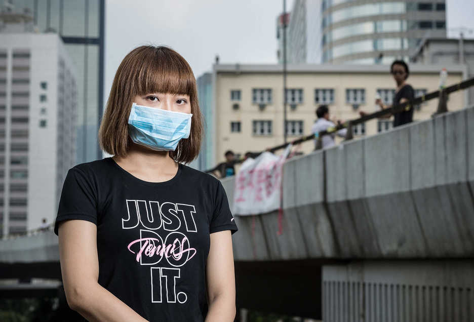 Pro-democracy protester poses near an elevated roadway in Central, Hong Kong