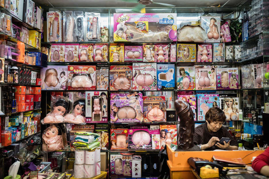A woman works in a shop selling adult toys in Guangzhou