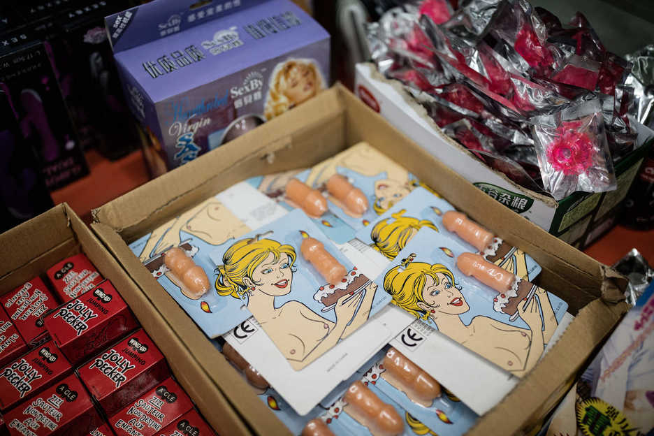 Penis-shaped novelty candles are displayed at an adult toy store.