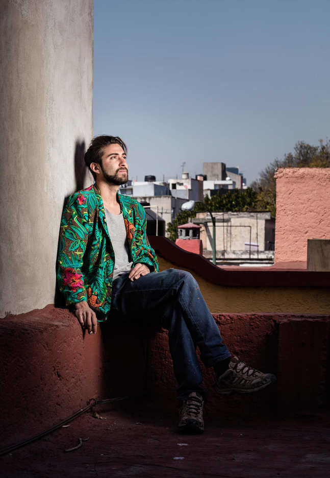 Angelo Barreto poses on a rooftop