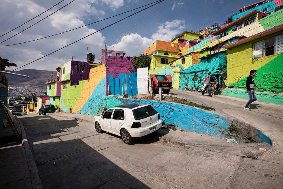 People walk down a street in Las Palmitas