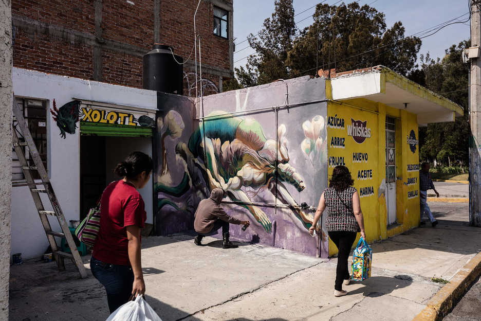 Muralist Saul Torbe paints in Pachuca