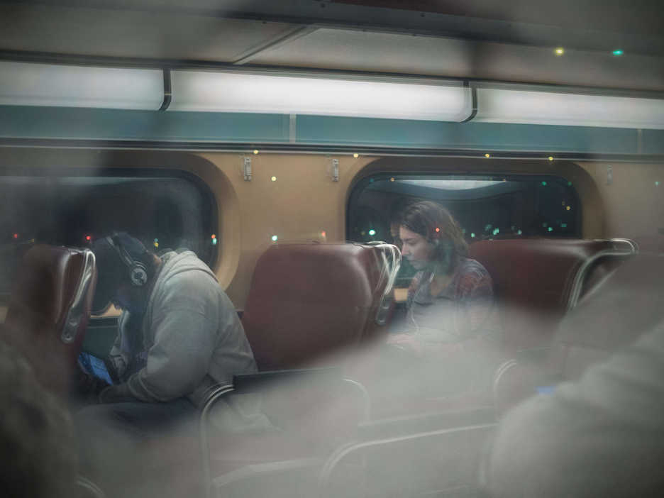 People sit in a commuter train car en route to Downers Grove Illinois