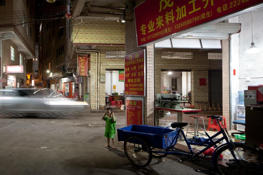 A child plays on a street in Yongtai Village