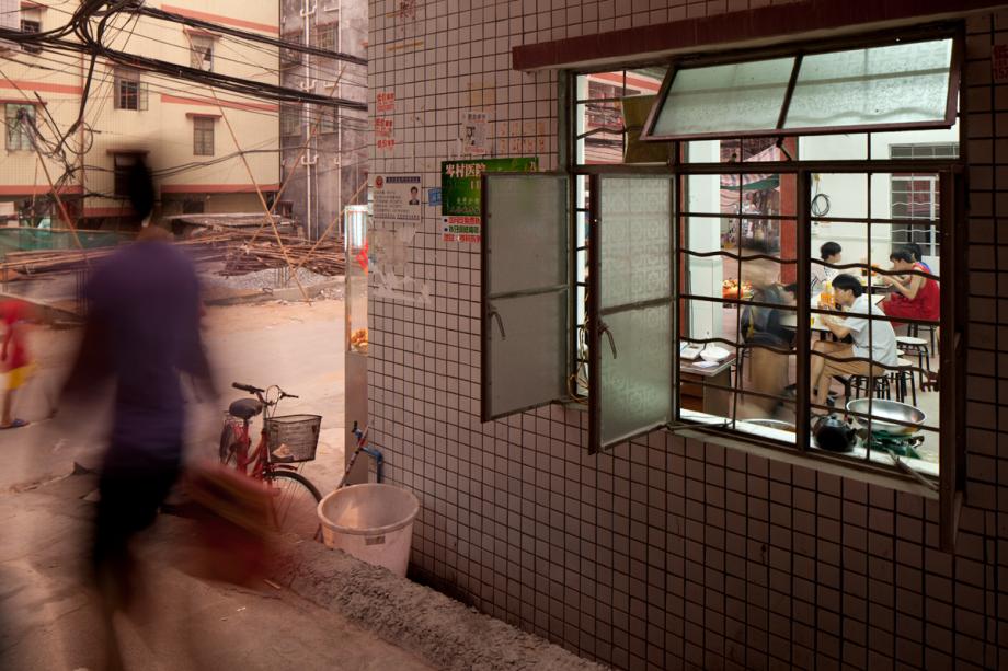 Diners eat at a small restaurant in Cencun, Tianhe District, Guangzhou, China