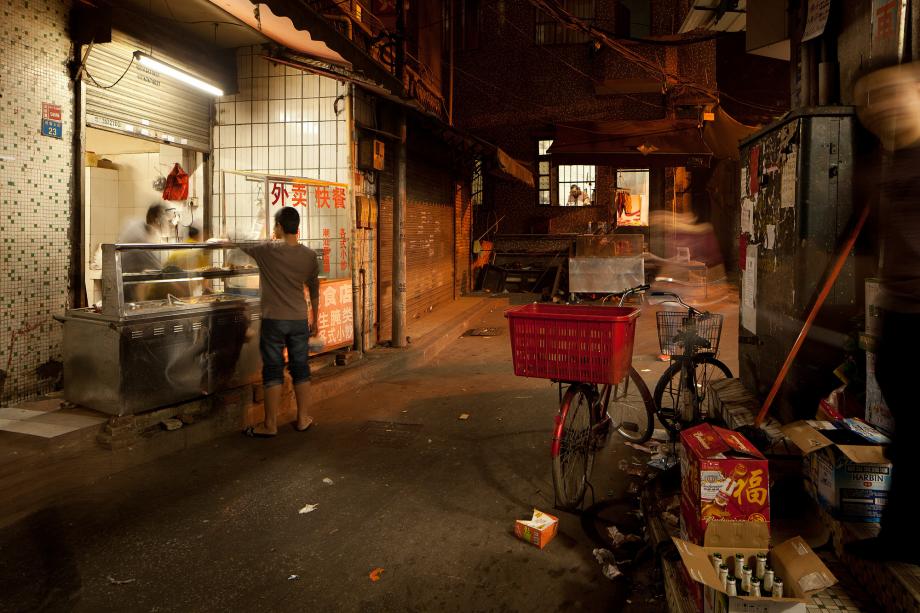 A shop sells food from outdoor carts in Sanyuanli Village