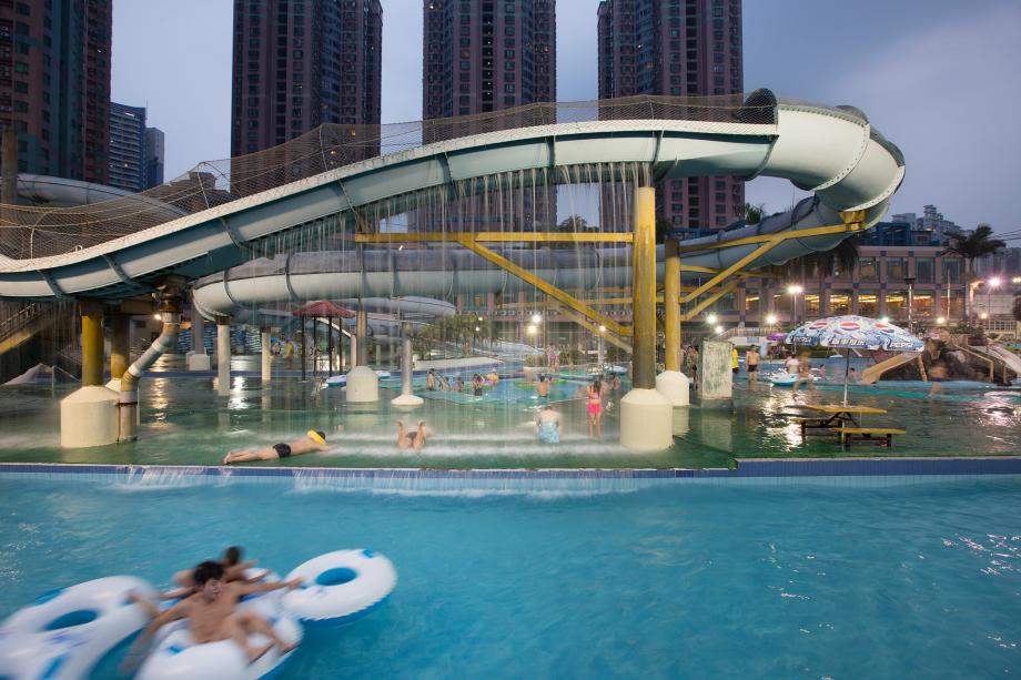 People swim at the Gold Coast Water Park in Haizhu District, Guangzhou, China
