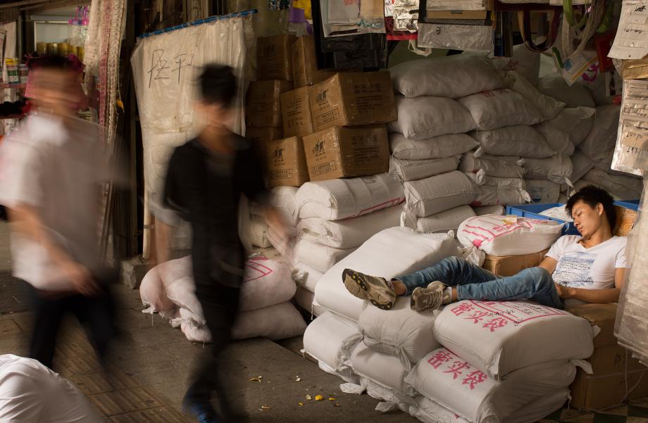 A worker naps at the Yide Lu wholesale market in Haizhu District