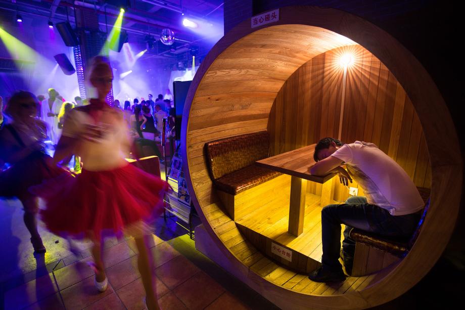 A man sleeps at the One club opening in Guangzhou, China