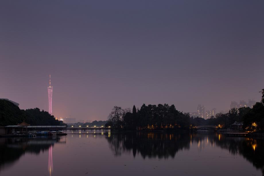 Dongshanhu Park and the Guanghou Tower are illuminated at dusk in Guangzhou, China.